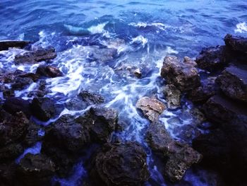 High angle view of rocks in sea