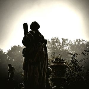 Statue of woman in cemetery