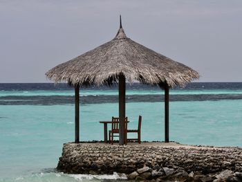 Gazebo on beach against sky