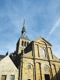 Low angle view of mont saint-michel against sky