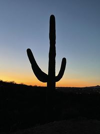 Low angle view of silhouette man standing against clear sky