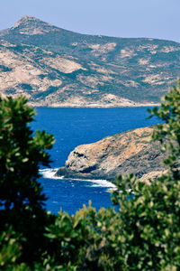 Scenic view of sea and mountains against sky