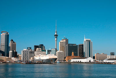 View of buildings in city against blue sky