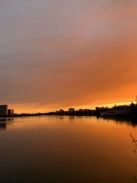 Scenic view of lake against romantic sky at sunset