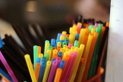 Close-up of colorful straws in desk organizer