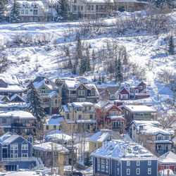 Snow covered houses and buildings in city