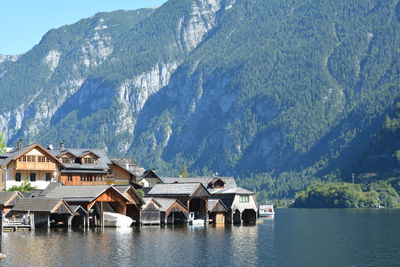 Houses by lake against mountains