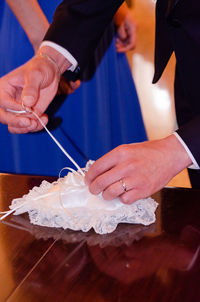 Midsection of man holding ice cream on table