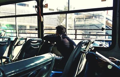 Side view of man sitting in bus