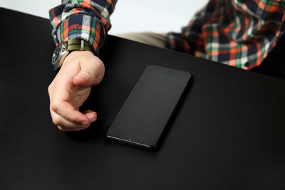 Midsection of man using digital tablet