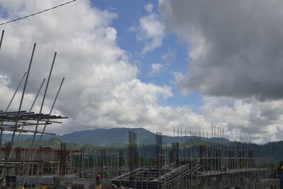 View of cars against cloudy sky