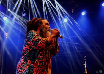 Low angle view of woman with illuminated lighting equipment in background