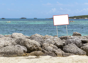 Scenic view of rocks on beach against sky