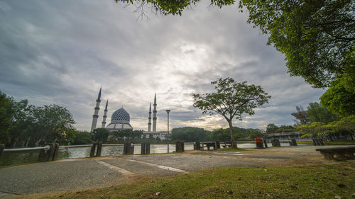 Panoramic view of trees and buildings against sky