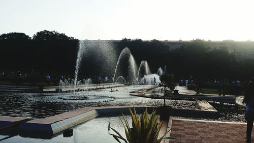 Fountain in park against clear sky