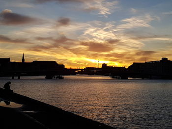 Scenic view of river against sky during sunset