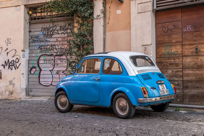 Vintage car on street against building