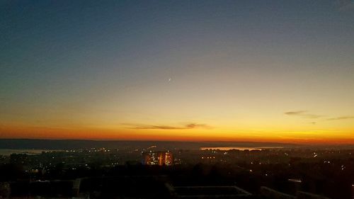 Aerial view of cityscape against sky during sunset