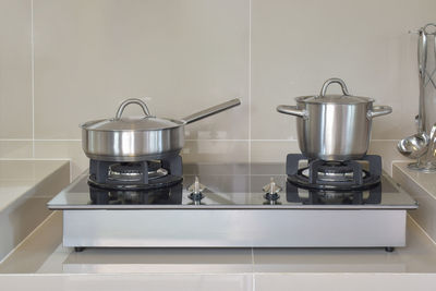 Close-up of kitchen utensils on stove at home