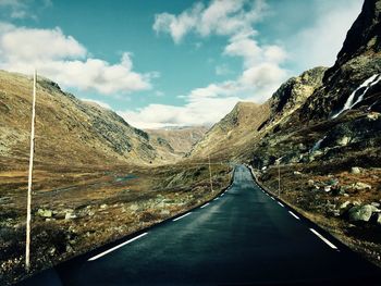 Road amidst mountains against sky