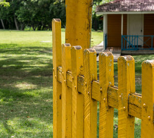 Yellow wooden fence on field