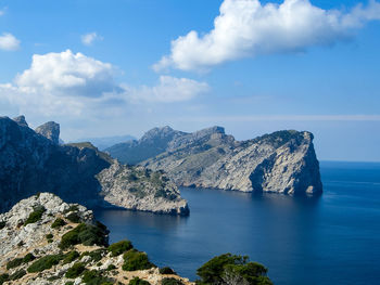 Scenic view of sea and mountains against sky