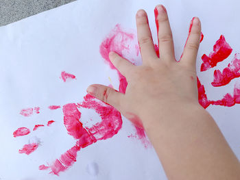 High angle view of woman painting on hand