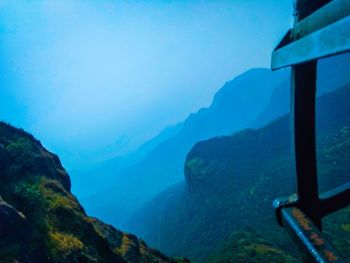 Scenic view of mountains against blue sky