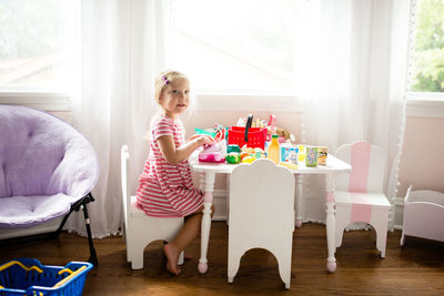 Side view girl in room playing store