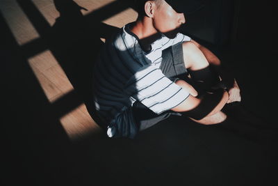 High angle view of woman sitting on floor