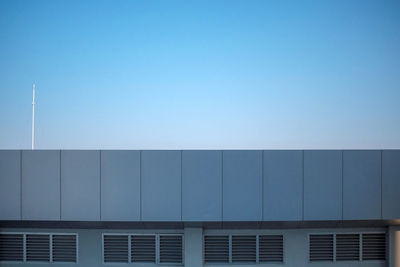 Low angle view of building against clear blue sky