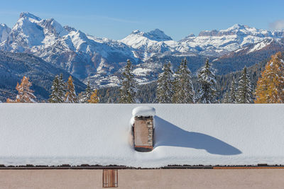 Alpine hut in front of an awesome winter scenery, val fiorentina, dolomites