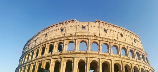 Low angle view of historical building against clear blue sky