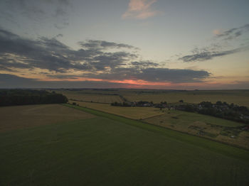 Scenic view of field against sky during sunset