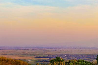 Scenic view of field against sky during sunset