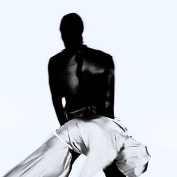 Rear view of woman standing against white background