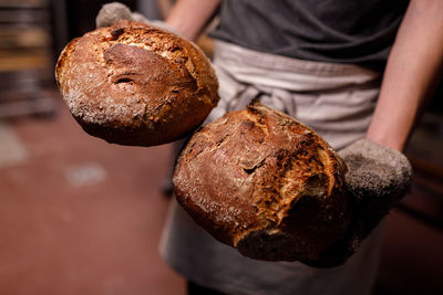 Close-up of hand holding 2 bread 
