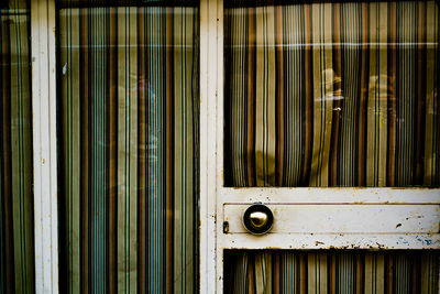 Closed glass door covered with curtain