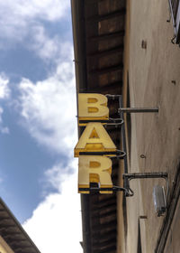 Low angle view of yellow building against sky