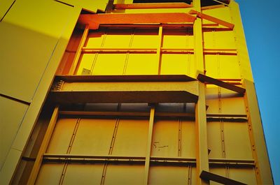 Low angle view of yellow building against sky