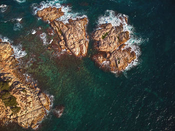 High angle view of rock formation in sea