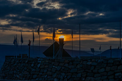 View of sailboats in city during sunset