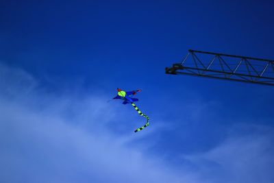 Low angle view of kite against blue sky