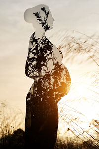 Silhouette woman standing by tree against sky during sunset