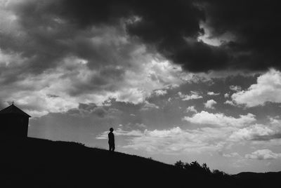 Silhouette man standing against sky