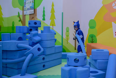 Close-up of toys against blue wall