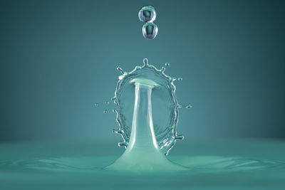 Close-up of water splashing against blue background