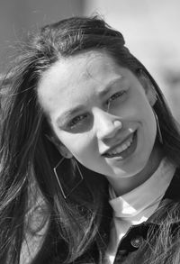 Close-up portrait of a smiling young woman