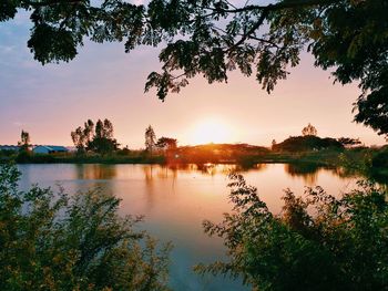 Scenic view of lake against sky at sunset