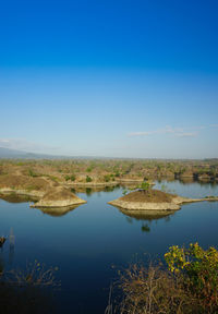 Scenic view of lake against blue sky